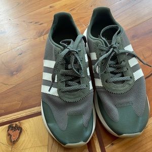 Olive green and white Adidas sneakers